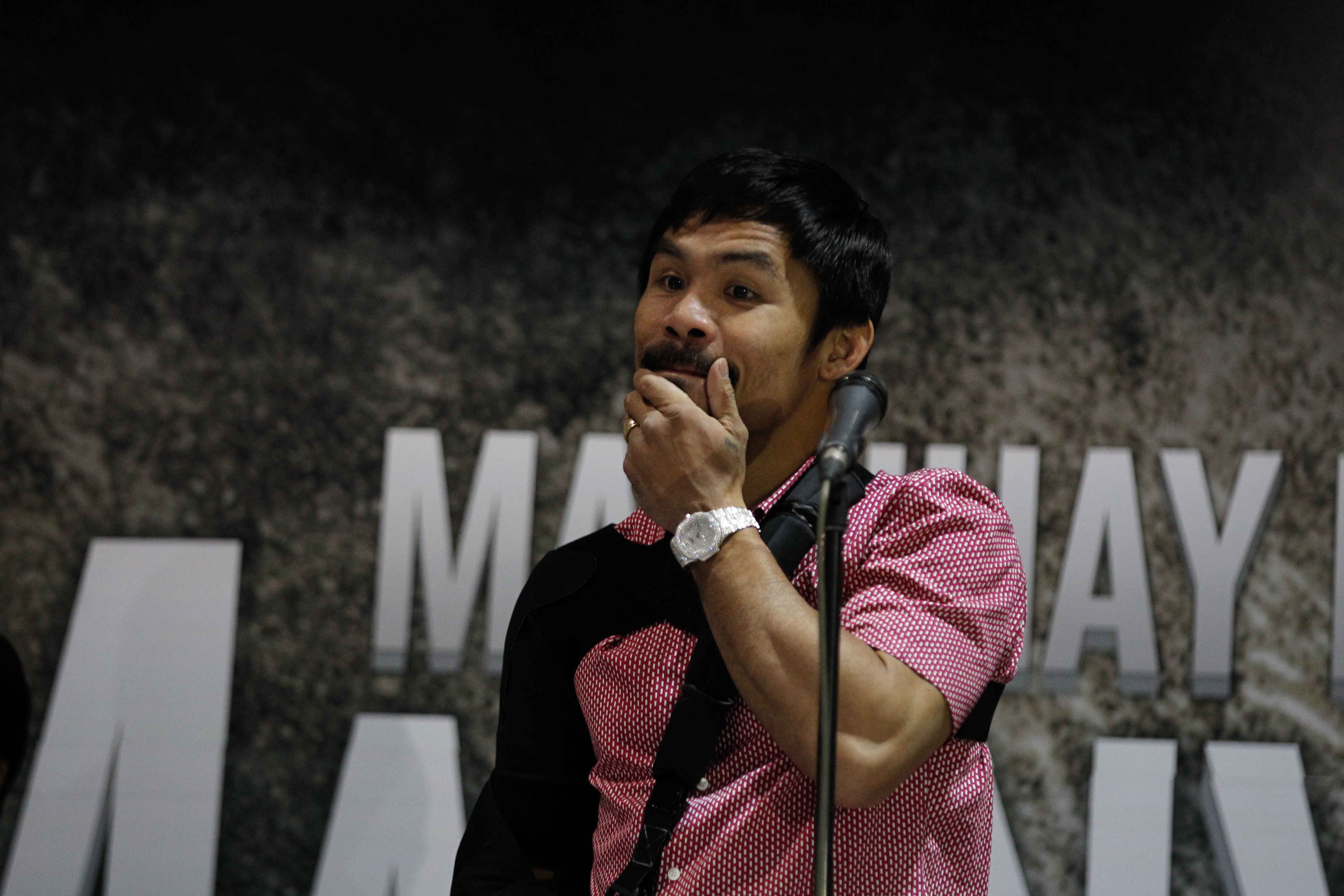 Filipino boxer Manny Pacquiao gestures as he arrives in Manila, Philippines on May 13, 2015. Photo by Czeasar Dancel 