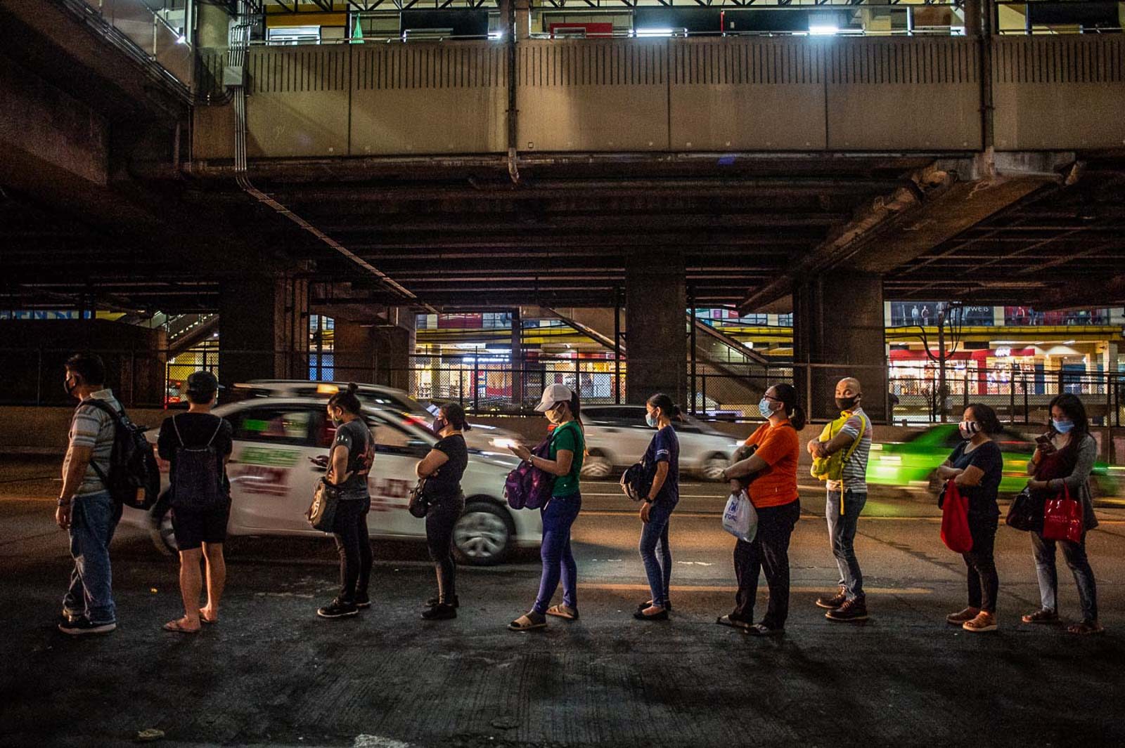 PHYSICAL DISTANCING. Commuters waiting for buses observe physical distancing as they queue along EDSA in Quezon City on July 3, 2020. Photo by Lisa Marie David/Rappler 