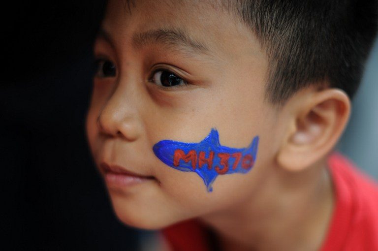 REMEMBRANCE CEREMONY. A boy with his face painted with the missing Malaysia Airlines flight MH370 logo looks on during a memorial event in Kuala Lumpur on March 6, 2016. Photo by Mohd Rasfan/AFP 