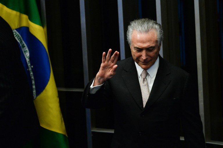 IN. President Michel Temer waves as he takes office before the plenary of the Brazilian Senate in Brasilia, on August 31, 2016. Andressa Anholete/AFP 
