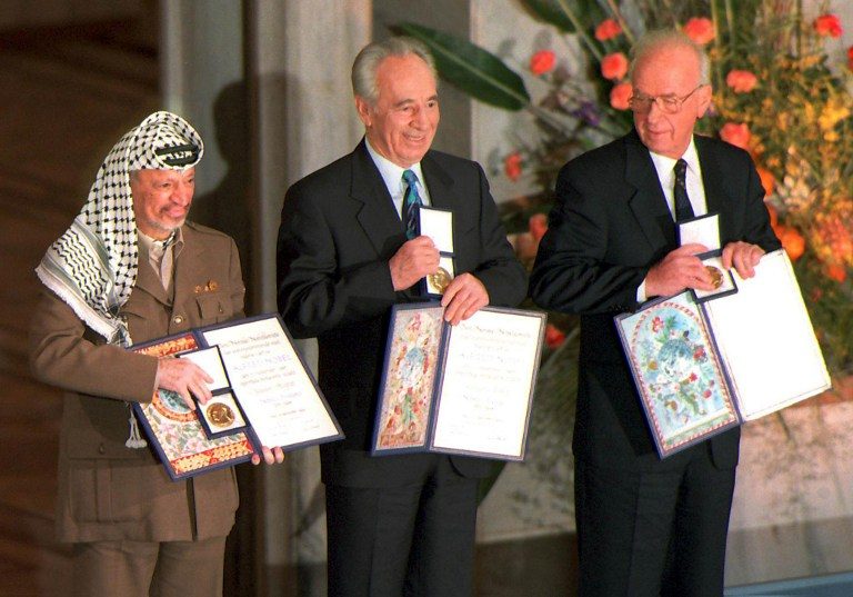STATESMEN. A picture dated 10 December 1994 of (from left) Palestinian leader Yasser Arafat, then Israeli Foreign Minister Shimon Peres, and late Israeli Prime Minister Yitzhak Rabin as they pose with the Nobel Peace Prize, which they were awarded in the Oslo City Hall. Erik Johansen/Scanpix/AFP 