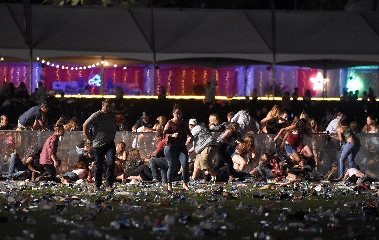 RUNNING FOR COVER. People run from the Route 91 Harvest country music festival after apparent gun fire was heard on October 1, 2017 in Las Vegas, Nevada. David Becker/Getty Images/AFP 