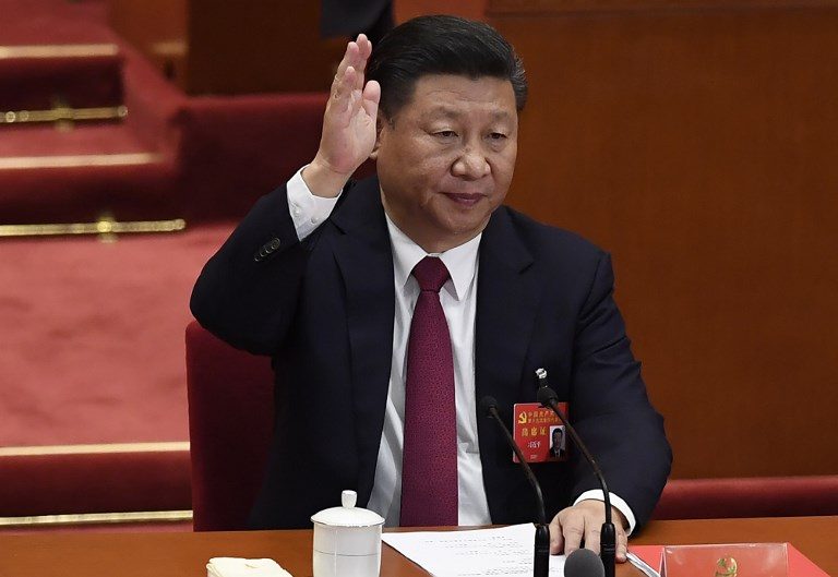 HEAD OF STATE. Chinese President Xi Jinping raises his hand to vote for reports with other Chinese leaders at the closing of the 19th Communist Party Congress at the Great Hall of the People in Beijing on October 24, 2017. Photo by Wang Zhao/AFP     