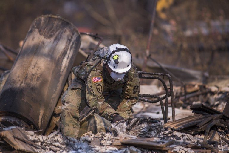 WHAT'S LEFT. California National Guard troops search burned homes near Mark West Springs Road and Old Redwood Highway on October 15, 2017 in Santa Rosa, California. Photo by David McNew/Getty Images/AFP  