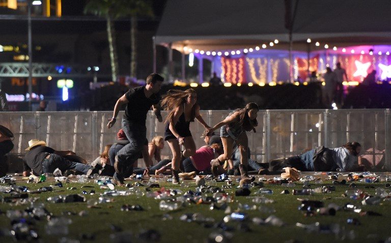 People run from the Route 91 Harvest country music festival after apparent gun fire was heard on October 1, 2017 in Las Vegas, Nevada. David Becker/Getty Images/AFP 