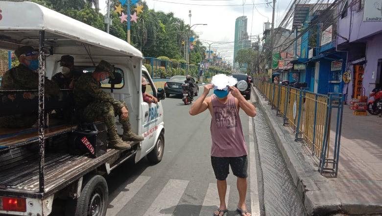 FREE TO GO. After getting a reprimand, a warning, and a face mask, this man was sent on his way by a group of Army reservists. Photo from the Mandaluyong CDRRMO 