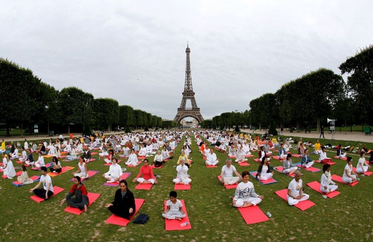 YOGA DAY PREPS. Participants take part in a mass yoga event on the Champs de Mars in front of the Eiffel tower in Paris on June 17, 2018, in celebration of International Yoga Day on June 21. Photo by Francois Guillot/AFP 