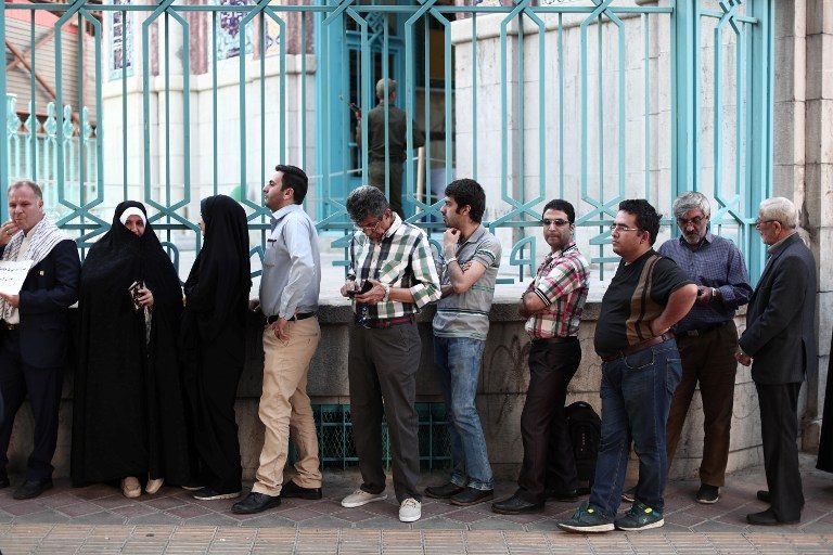 Iran votes in verdict on Rouhani’s economy, diplomacy