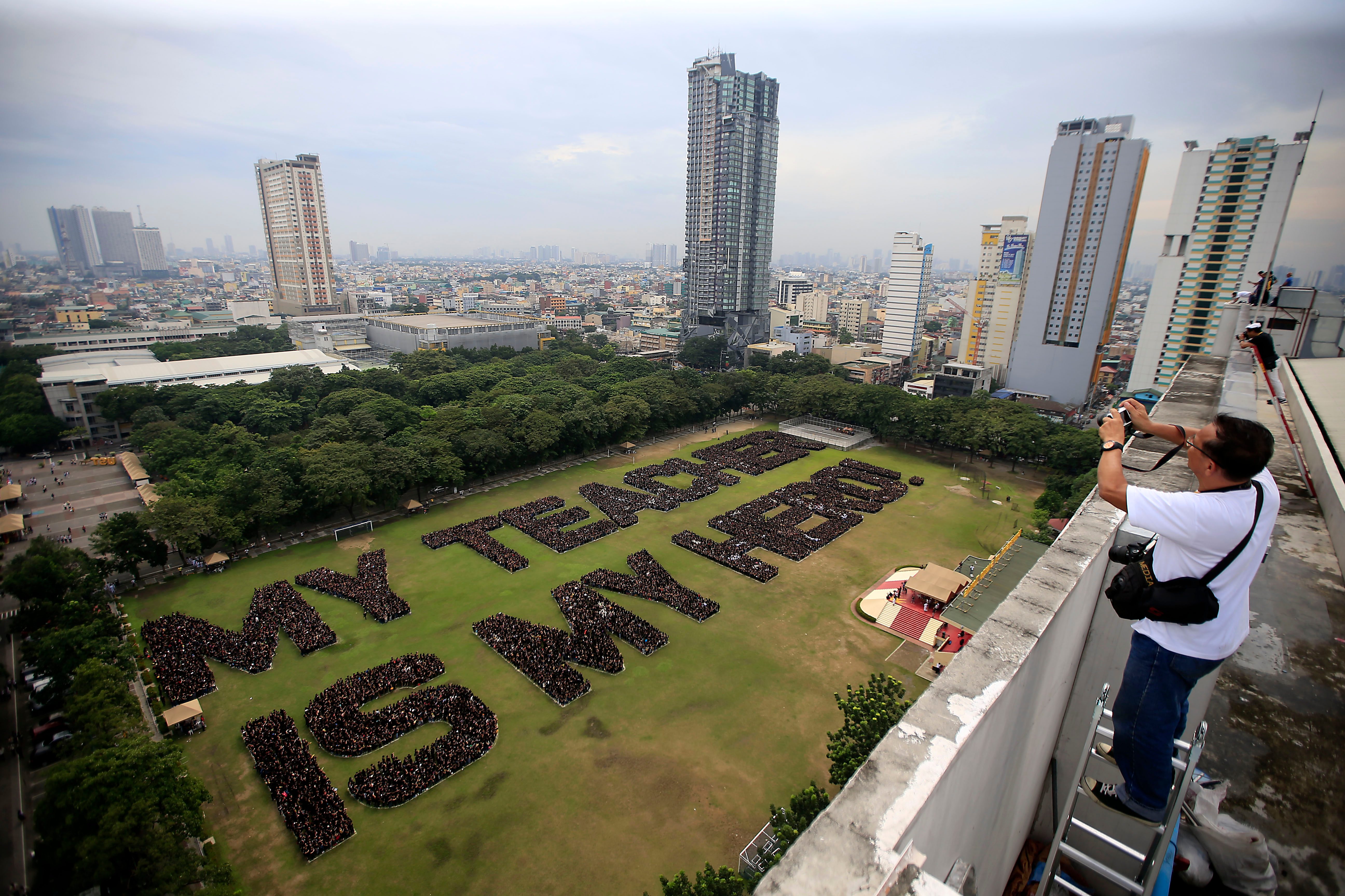 SAY 'CHEESE'. Photographers take snapshots as UST students form a "My Teacher is My Hero"in their bid for the Guinness World Record for Largest Human Sentence at the open field of the UST in Manila on September 29, 2017, in observance of National Teacher's Month. Photo by Inoue Jaena/Rappler  