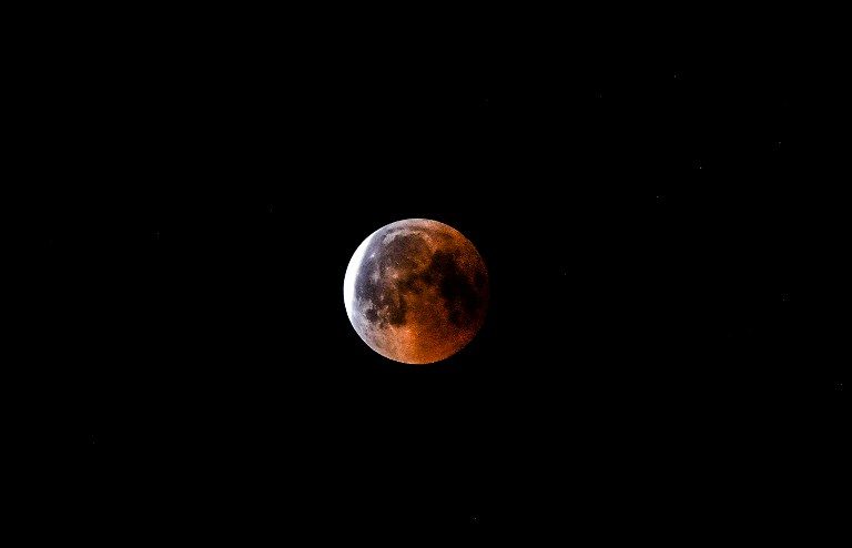 This picture shows the full moon during a 'blood moon' eclipse as seen from the eastern Turkey city of Tunceli on July 27, 2018.
The longest "blood moon" eclipse this century began on July 27, coinciding with Mars' closest approach in 15 years to treat skygazers across the globe to a thrilling celestial spectacle. / AFP PHOTO / BULENT KILIC 