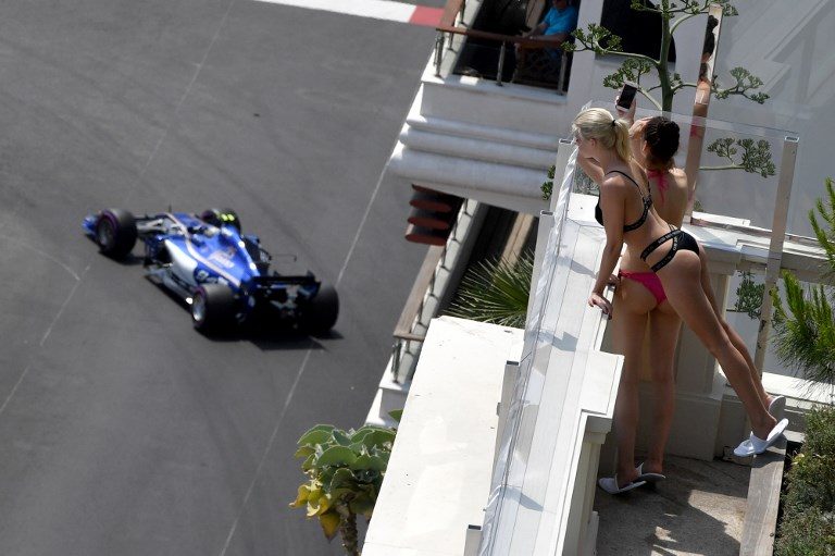 MONACO GRAND PRIX. Women look on as Sauber's German driver Pascal Wehrlein steers his car during the second practice session at the Monaco street circuit on May 25, 2017. Photo by Andrej Isakovic/AFP  