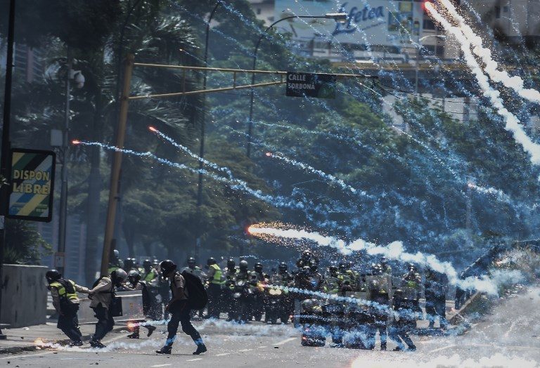 UNREST. Riot police clash with opposition demonstrators in Caracas, on May 24, 2017. 
Venezuela's President Nicolas Maduro formally launched moves to rewrite the constitution on Tuesday. Photo by Juan Barreto/AFP   