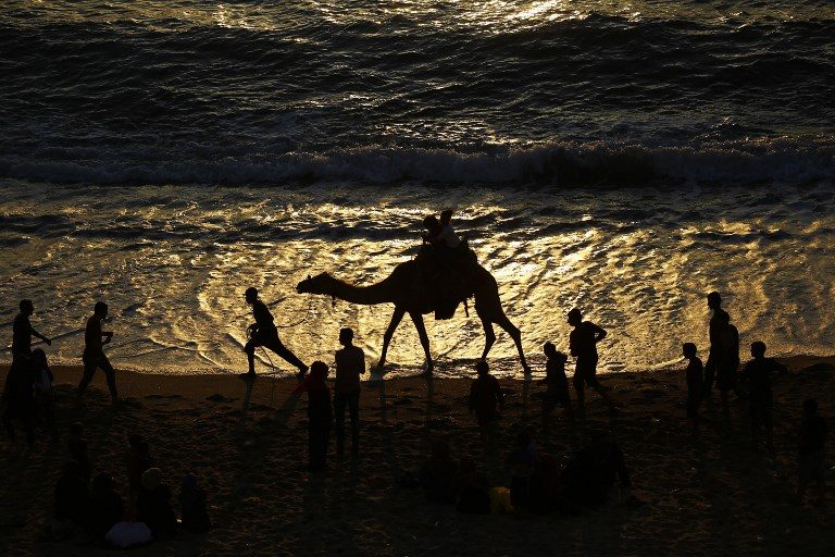 CONFLICT ZONE. Palestinians spend time at the beach at sunset in Gaza City on May 24, 2017. Photo by Mohammed Abad/AFP  