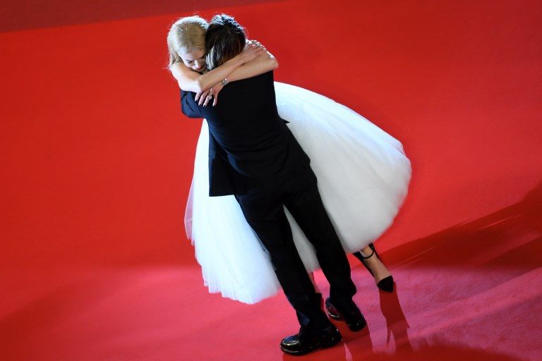 CANNES FILMFEST. Nicole Kidman hugs her husband Keith Urban as they leave the Festival Palace on May 22, 2017 following the screening of the film 'The Killing of a Sacred Deer' at the 70th edition of the Cannes Film Festival. Photo by Anne-Christine Poujoulat/AFP  
