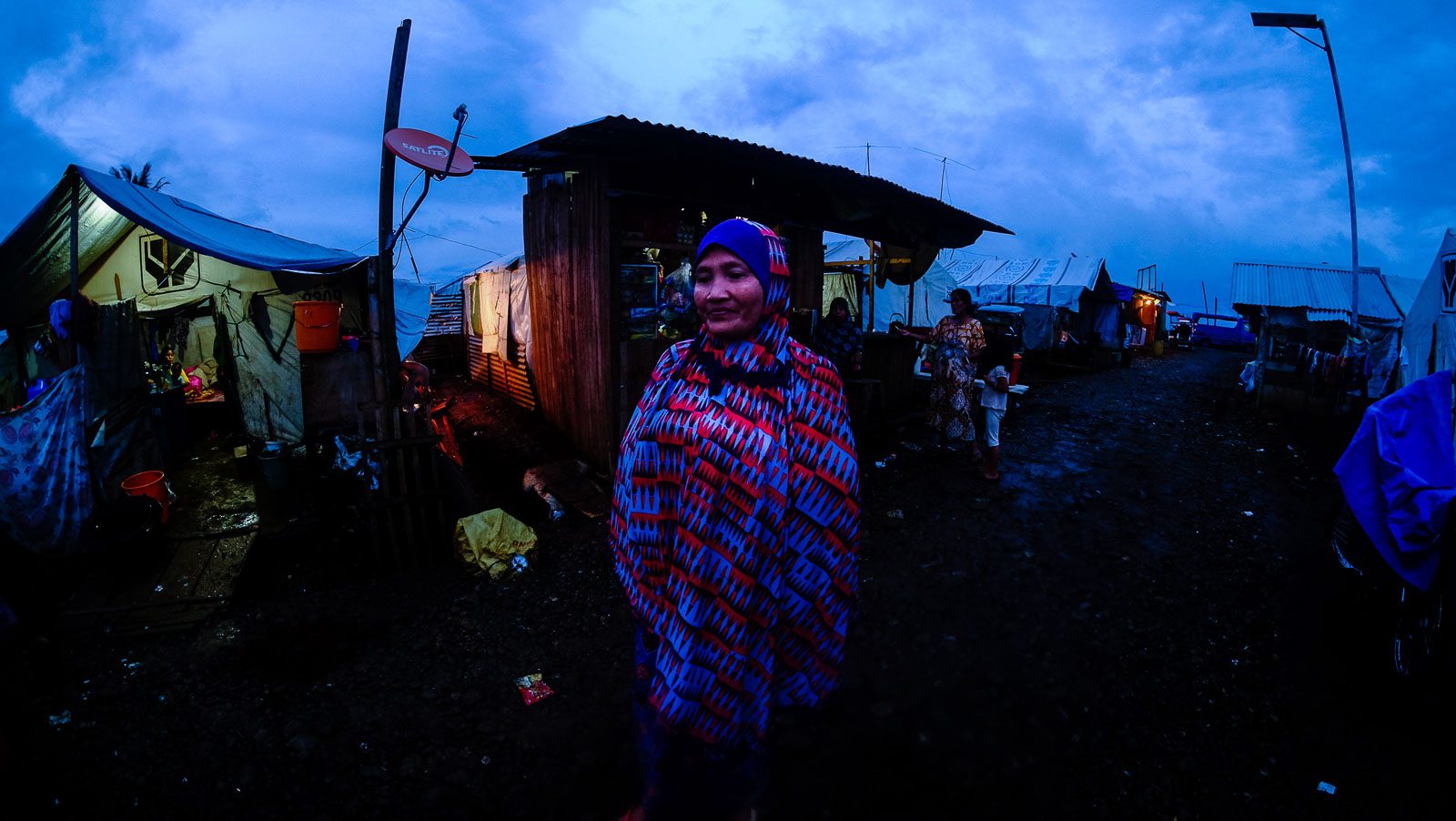 EVE. A Maranao woman stands outside her family's tent in Sarimanok Tent City on the eve of Eid'l Fitr, June 4, 2019. 