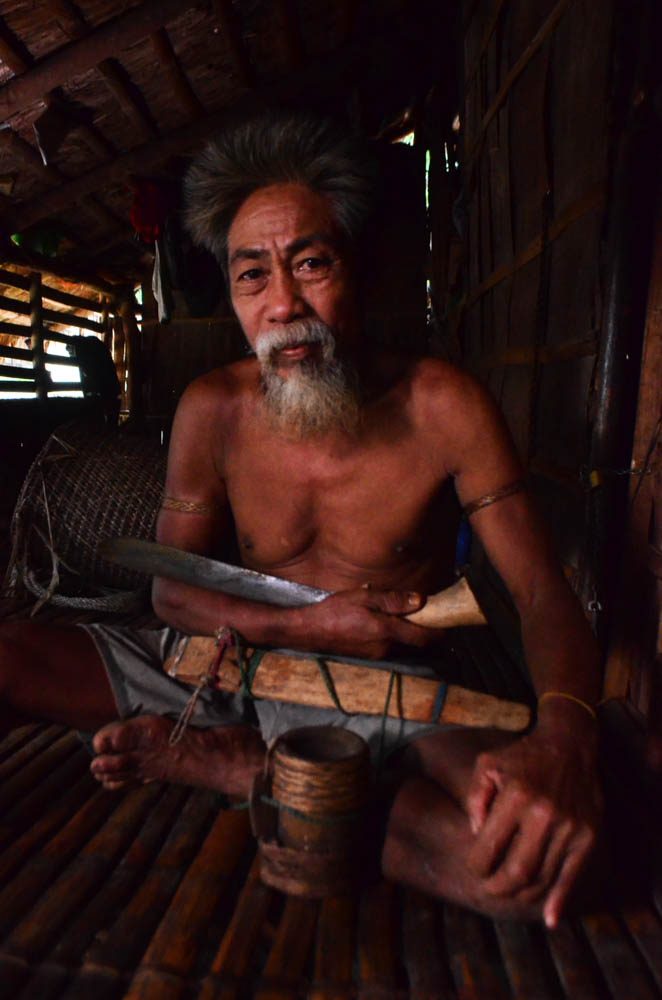CHIEF. Punong Tribo Fausto Novelozo inside his modest hut in Tamisan Dos, at the foothills of the Mounts Iglit-Baco Natural Park in Occidental Mindoro. Photo by Gregg Yan/UNDP BIOFIN 