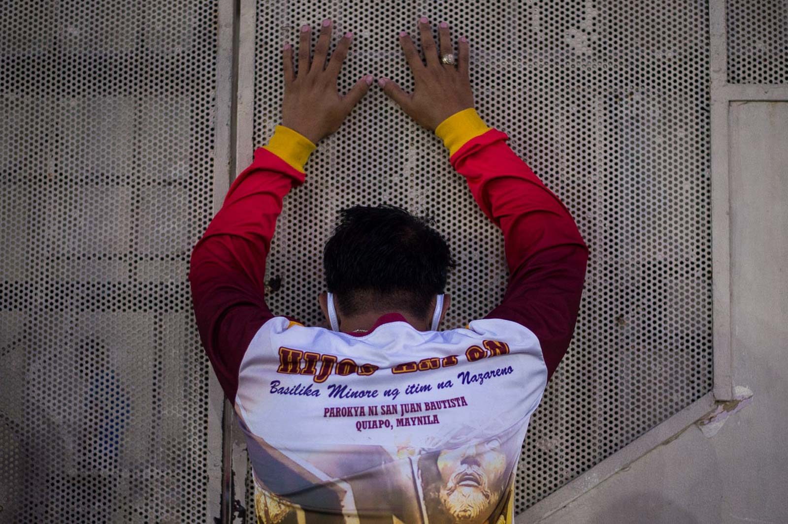 'HEAR US.' Devotees solemnly pray before the closed gates of Quiapo Church in Manila on Good Friday, April 10, 2020, as Luzon remains on lockdown due to COVID-19. Photo by Lisa Marie David/Rappler  