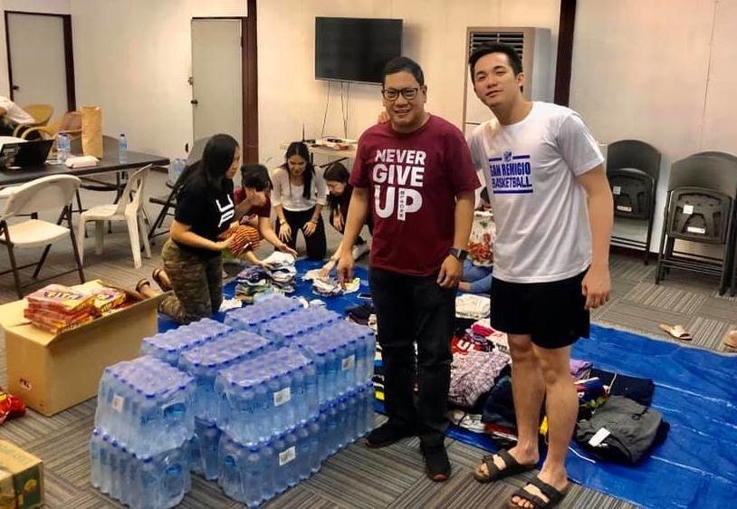 LOOK: U.P. athletes show teamwork in packing Taal eruption relief goods
