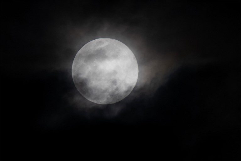 MARYLAND. A super worm moon, occurring on the same day as the equinox, is seen through passing clouds over Joint Base Andrews in Maryland, March 20, 2019. Photo by Saul Loeb/AFP  