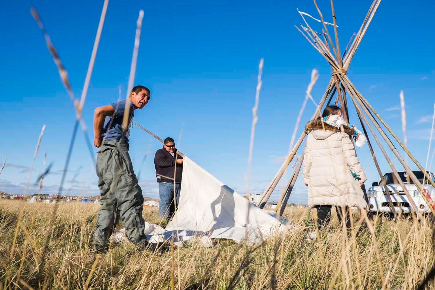 Native Americans from Iowa help build a tepee at the Oceti Sakowin camp. October 7, 2016. Photo by Pat Nabong/MEDILL 