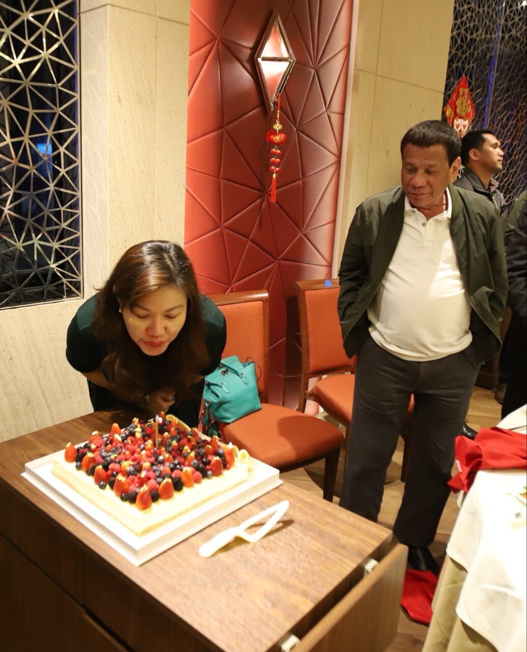 BIRTHDAY. President Rodrigo Duterte looks on as his longtime partner Honeylet Avanceña blows a birthday cake in Hong Kong on February 16, 2019. Photo from Bong Go 