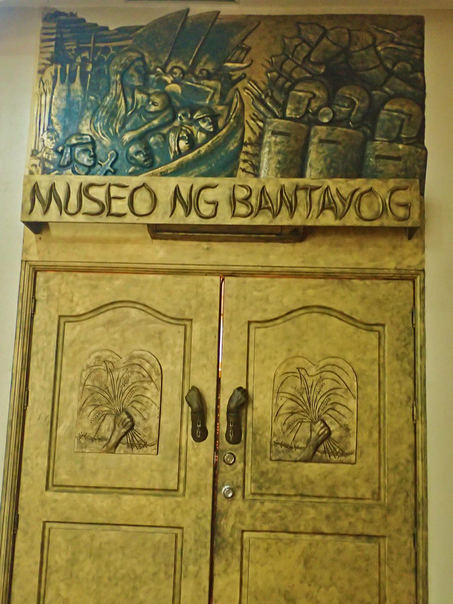 MUSEUM ENTRANCE. The door to the museum has images of struggle and peace during the Marcos regime. 
