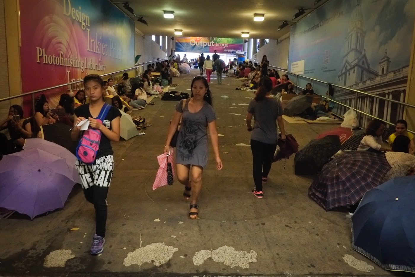 OVER-UNDER. When the rains hit Hong Kong on Sundays, or when the sun is too hot to bear, Filipino domestic workers find their place in pedestrian underpasses. 