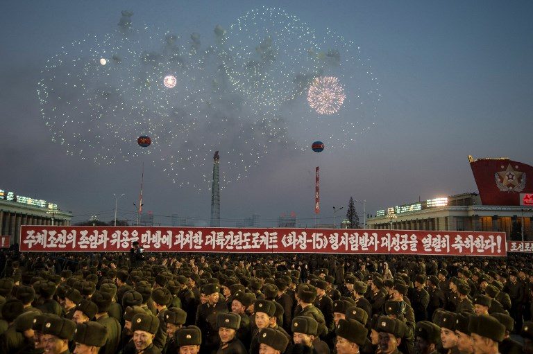 CELEBRATION. North Korean soldiers watch a fireworks display to celebrate the North's declaration of achieving full nuclear statehood during a mass rally on Kim Il-Sung Square in Pyongyang on December 1, 2017. Photo by Kim Won-Jin/AFP   