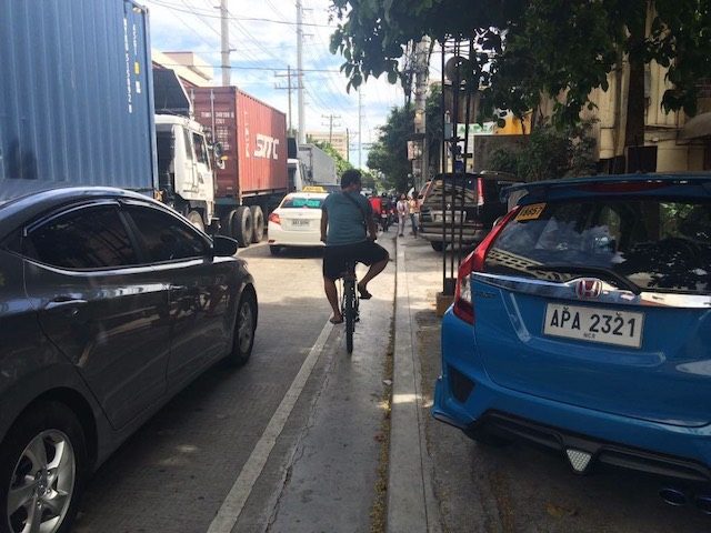 A SLIVER OF SPACE. In Metro Manila, cars are everywhere. Although a mere 1% of Filipinos own cars, people in four-wheeled vehicles hog the space on the road. This forces people on bicycles to squeeze into tiny spaces. Photo from Julia Nebrija 