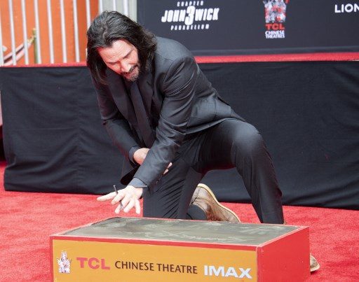 Keanu Reeves sinks hands, feet at Hollywood’s Chinese Theatre