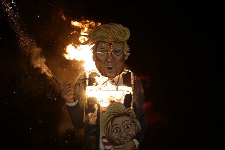 US ELECTIONS. The giant effigy of US presidential candidate Donald Trump wielding the head of rival Hillary Clinton goes up in flames during the traditional British bonfire celebrations at Edenbridge, south of London. File photo by Daniel Leal-Olivas/AFP 