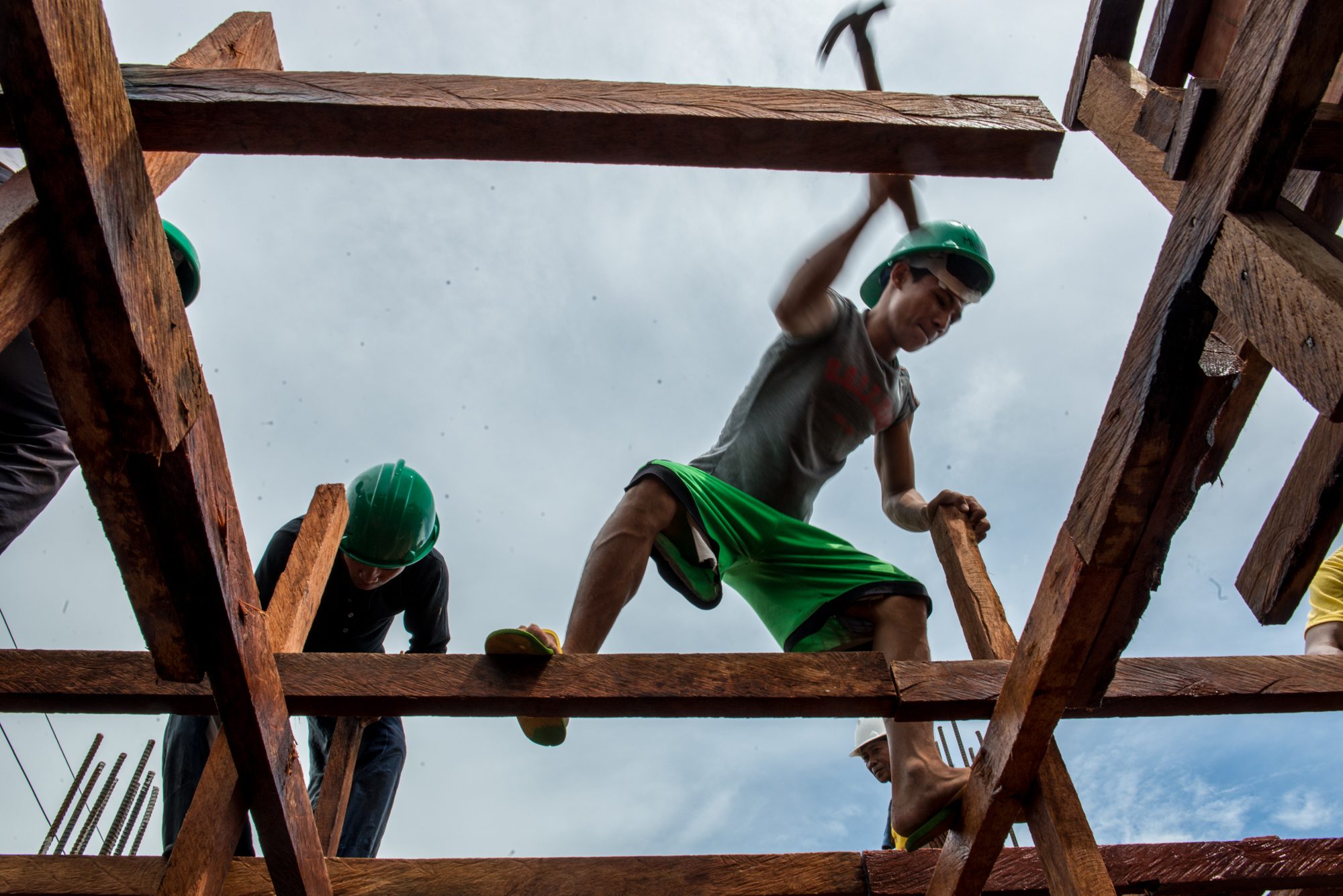 REBUILDING. Carpenters build new classrooms at the Bislig Elementary School in Tanauan, Leyte. Photo by Ariel Javellana/ADB     