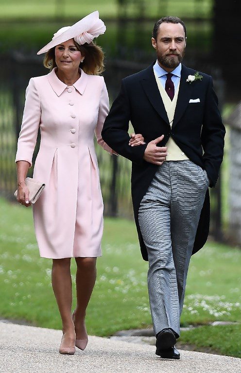 James Middleton (R), brother of the bride, walks with his mother Carole Middleton as they attend the wedding of Pippa Middleton and James Matthews at St Mark's Church in Englefield, west of London, on May 20, 2017. Photo by Justin Tallis/AFP Photo 
