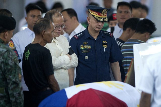 Philippine President Benigno Aquino with PNP-OIC Chief Leonardo Espina looks at the coffin of one of the 44 police commandos killed in a botched anti-terror operation during a necrological service at the Camp Bagong Diwa, in Manila on January 30, 2015. Photo by Noel Celis/AFP    