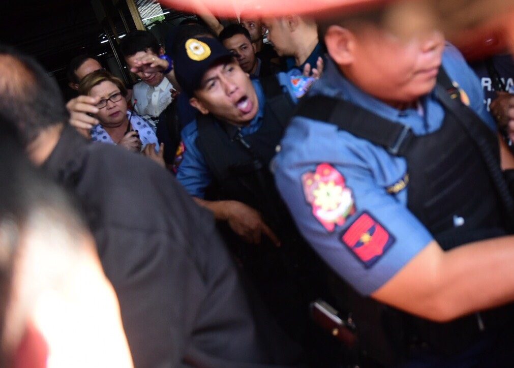 DRUG CHARGES. Senator Leila de Lima is brought by the police to a van that would bring her to Camp Crame. Photo by Alecs Ongcal/Rappler 