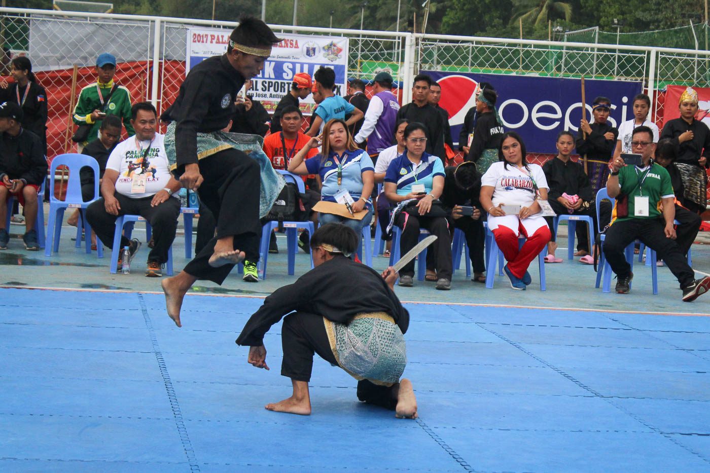FROM ABOVE. Atheletes perform the flying knee strike.  