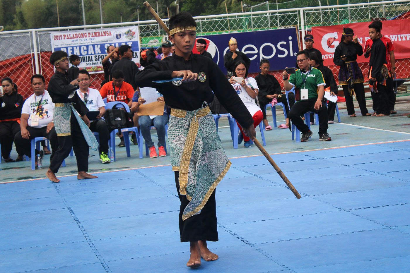 END OF ROUND. A Pencak Silat competitor is equipped with Pisau and Toya.  