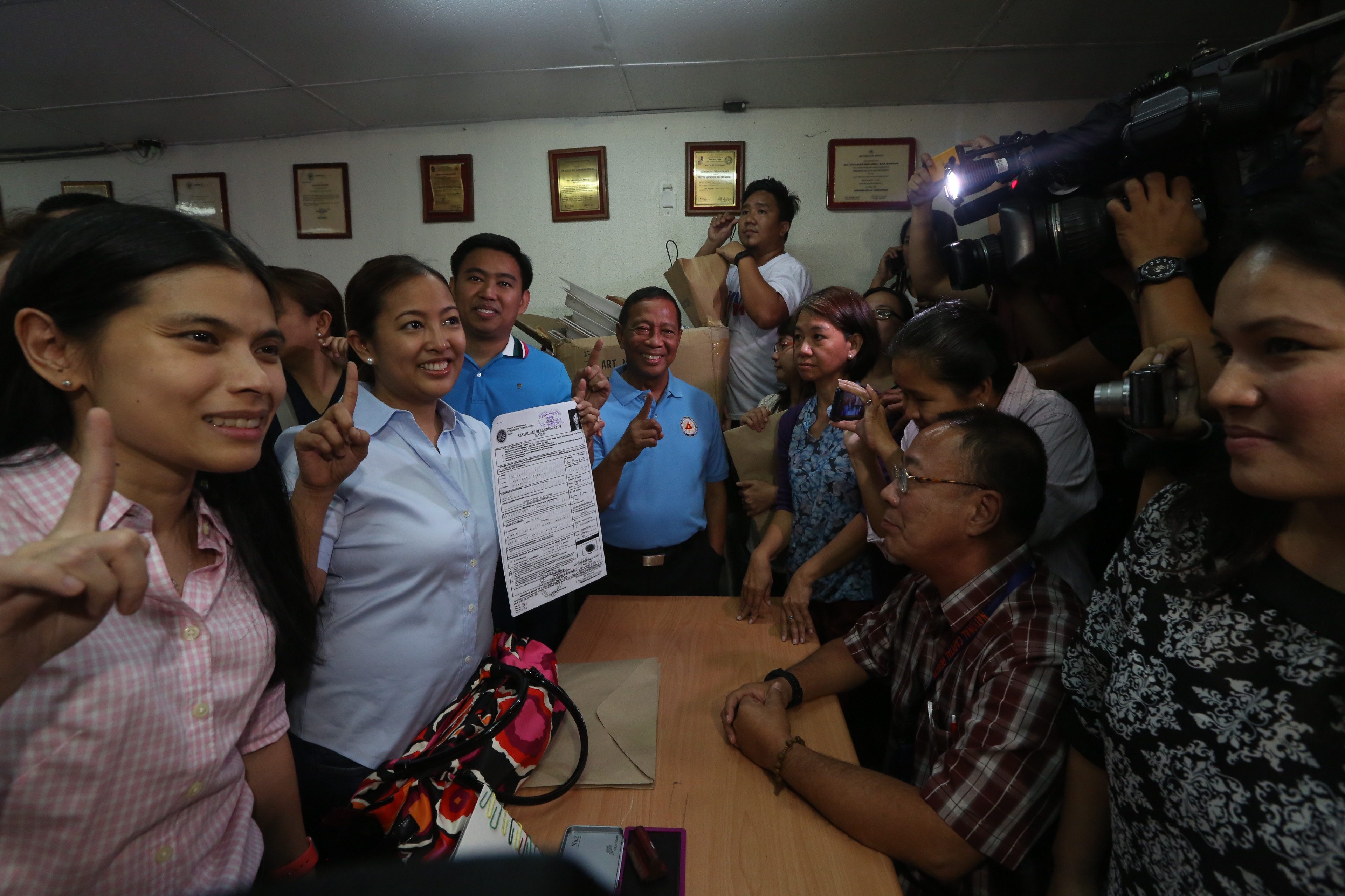 ALL-OUT SUPPORT. VP Binay (center, in blue) accompanies his daughter Abby (2nd from left) as she files her certificate of candidacy (COC) for mayor on October 15. Abby plans to follow her father's footsteps if she wins. Photo by the Office of the Vice President Media Affairs    