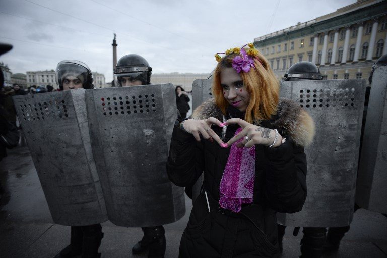 ELECTION PROTEST. A woman gestures in front of riot police during a rally calling for a boycott of March 18 presidential elections in Saint Petersburg, Russia on January 28, 2018. Photo by Olga Maltseva/AFP    