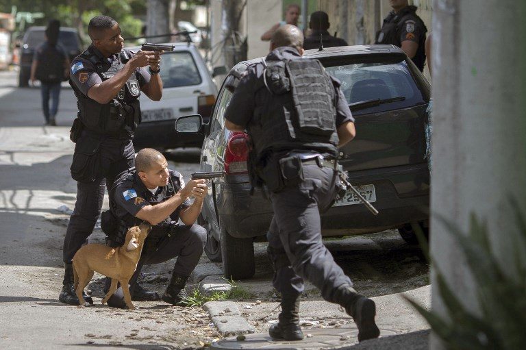 POLICE OPS. Military policemen take part in an operation at Cidade de Deus favela in Rio de Janeiro, Brazil, on February 1, 2018. Photo by Maurio Pimentel/AFP   