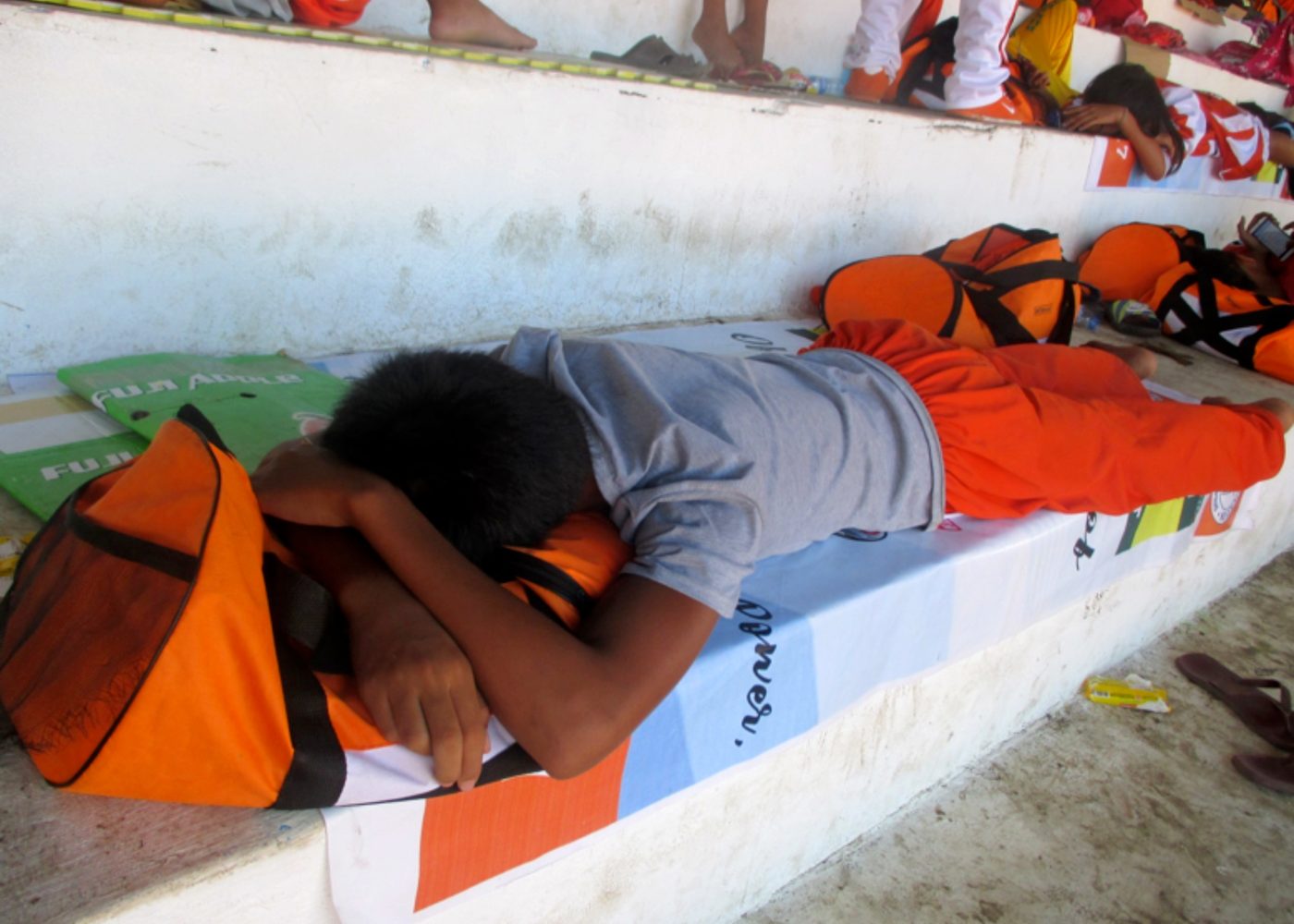TIME OUT. An athlete from Northern Mindanao take a nap at the grandstand of Binirayan Sports Complex. 