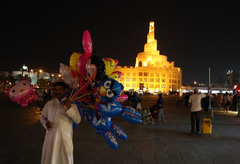 LIFE GOES ON. A Qatari man sells balloons in front of the Fanar mosque at the popular Souq Waqif market in Doha on June 7, 2017. Photo by AFP   