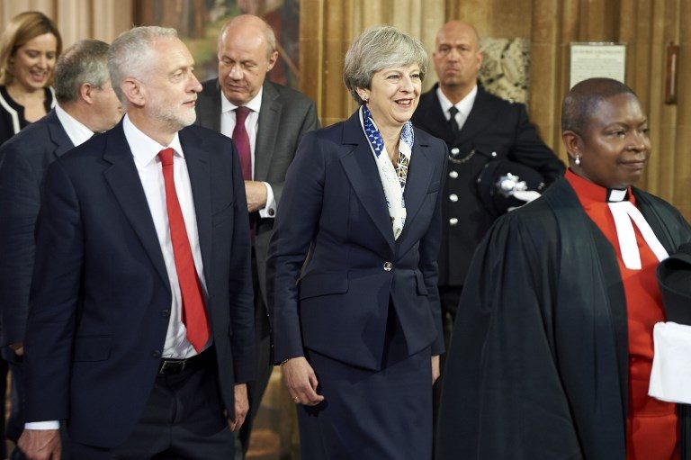 PARLIAMENTARY LEADERS. Britain's Prime Minister Theresa May (2R) and Britain's main opposition Labour Party leader Jeremy Corbyn (L) walk back across the Central Lobby of the Palace of Westminster from the House of Lords to the House of Commons after listening to the Queen's Speech during the State Opening of Parliament ceremony in London on June 21, 2017. Niklas Halle'n/Pool/AFP 