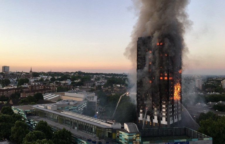 BLACKENED MASS. This handout image received by local resident Natalie Oxford early on June 14, 2017 shows flames and smoke coming from a 27-story block of flats after a fire broke out in west London. Natalie Oxford/AFP 