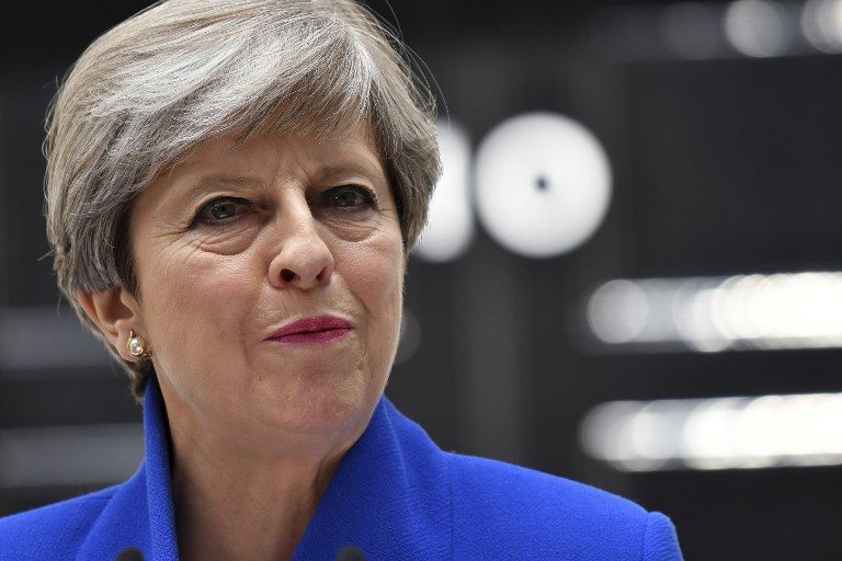 Defiant May vows to stay on despite UK election blow