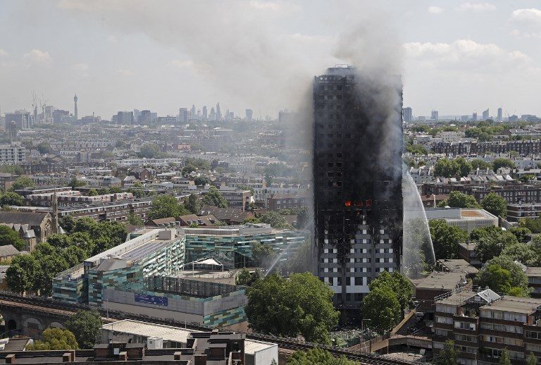 BLACKENED. Smoke and flames billows from Grenfell Tower as firefighters attempt to control a blaze at a residential block of flats on June 14, 2017 in west London. Adrian Dennis/AFP 
