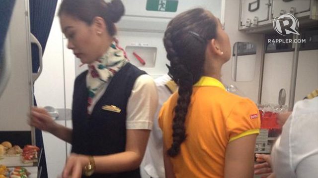 JOINT FORCES. Cabin crew of PAL and Cebu Pacific serve in the A350 XWB Manila demo flight.  