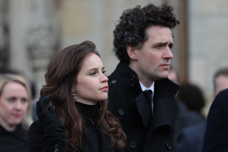 TRIBUTE. English actress Felicity Jones (L) and English producer/director Stephen Guard walk after the funeral service at the Church of St Mary the Great, in Cambridge on March 31, 2018. Felicity played the wife of Hawking's in 'The Theory of Everything.' Photo by Daniel Leal-Olivas/AFP 