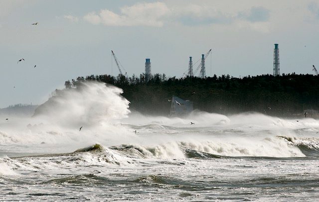 FOUR YEARS LATER. High waves surge at coast at Ukedo in Namie, about five km north of tsunami-crippled Tokyo Electric Company's Fukushima Daiichi Nuclear Power Plant (seen in rear), Fukushima Prefecture, northern Japan, 10 March 2015, the eve of fourth anniversary of the March 11 earthquake and tsunami in 2011. Kimimasa Mayama/EPA 