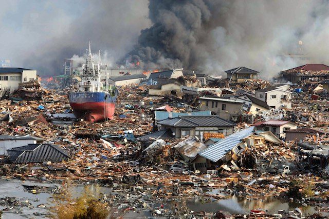 AFTERMATH. A file picture dated 12 March 2011 shows burning houses and ships piled midst Tsunami flood water in a mass of debris in Kisenuma city, Miyagi prefecture, Japan. Stringer/EPA 